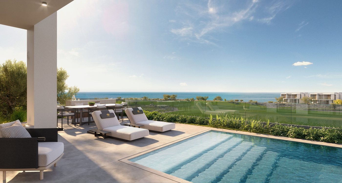 Villa terrace with a pool and loungers facing the golf course and the sea
