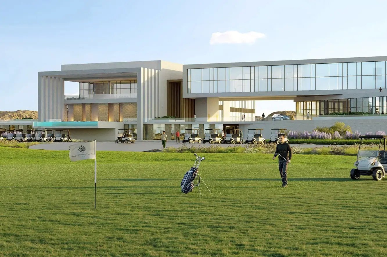 Golf clubhouse with golf carts and a golfer on the lawn